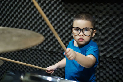 Portrait of boy playing drums