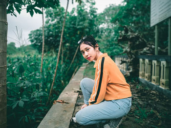 Portrait of young woman sitting outdoors