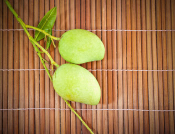 High angle view of raw mangoes on placemat