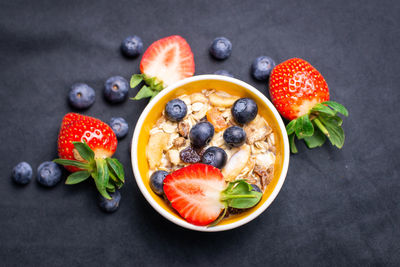 Directly above shot of breakfast served in bowl against black background