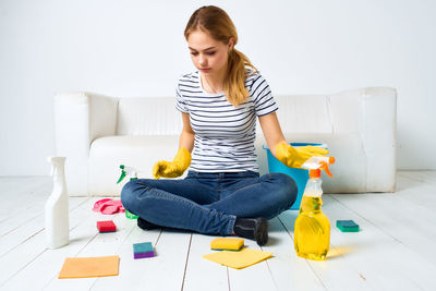 Young woman sitting on sofa at home