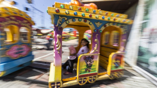 Blurred motion of woman with people in background