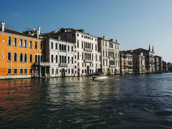 Buildings in city against clear sky