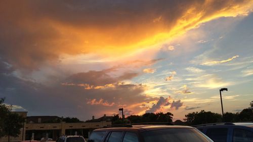 View of road against cloudy sky at sunset