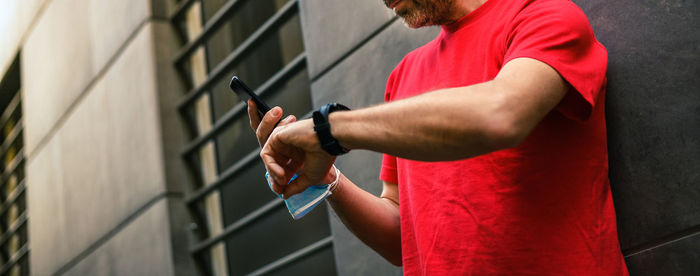 Side view of man standing against wall