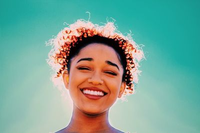 Happy woman against sky