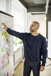 Businessman explaining business strategy in creative office