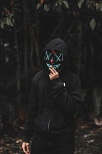Man wearing mask in forest