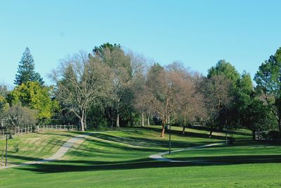 View of golf course against clear sky