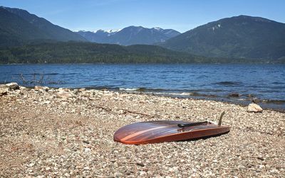 View of abandoned boat in calm lake