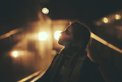 Woman in city at night