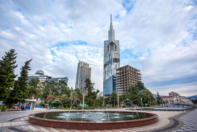 View of fountain in city against sky