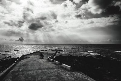 Narrow jetty leading to calm sea