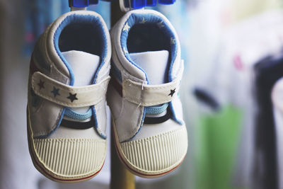 Close-up of shoes hanging from clothespins