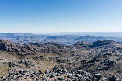 Scenic view of dramatic landscape against clear blue sky