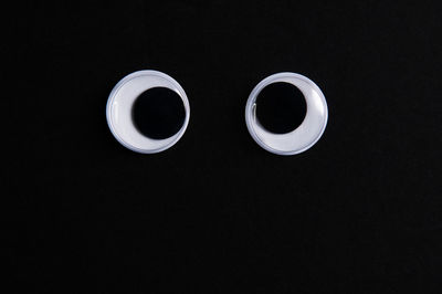 Directly above shot of coffee cup against black background