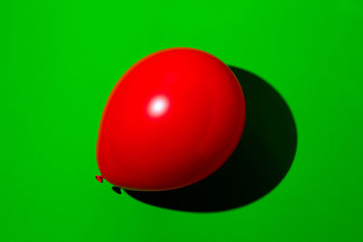 Close-up of red balloons against green background