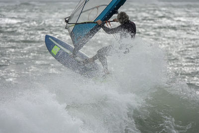 Man splashing water in sea