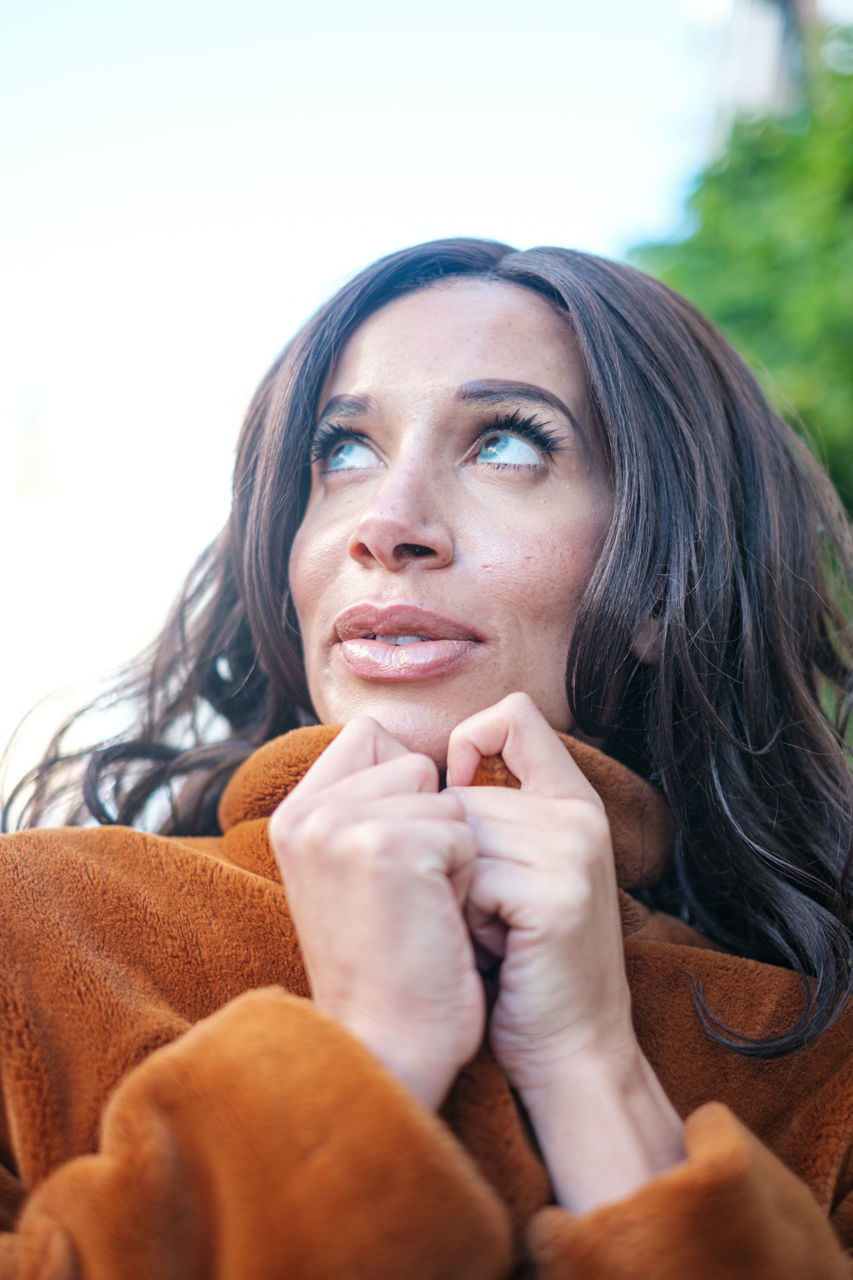 women, adult, one person, portrait, human face, female, young adult, person, emotion, looking, long hair, skin, lifestyles, contemplation, headshot, nature, hairstyle, relaxation, happiness, close-up, smiling, sky, brown hair, portrait photography, positive emotion, hand, leisure activity, photo shoot, nose, looking away, human eye, outdoors, enjoyment, clothing, copy space, casual clothing, human head