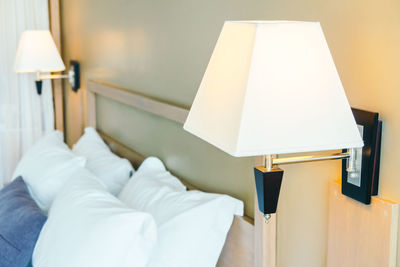 Close-up of electric lamp in bedroom