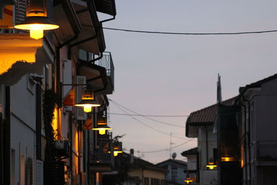 Low angle view of illuminated city against sky