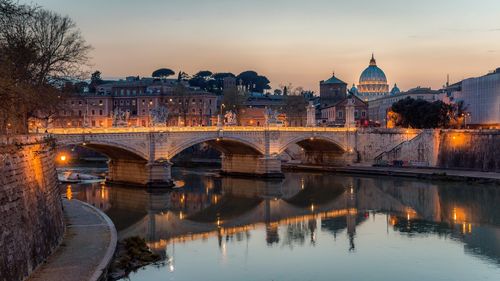 Bridge over river with city in background