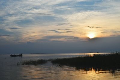 Scenic view of sea against sky at sunset