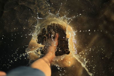 Low section of man splashing water 