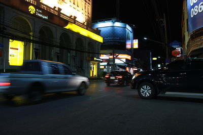 Cars on illuminated city at night