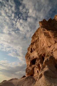 Low angle view of rock formation against sky
