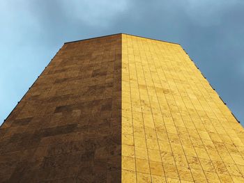 Low angle view of building against cloudy sky