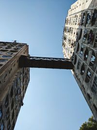 Low angle view of buildings against clear blue sky