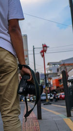 Midsection of man standing on street