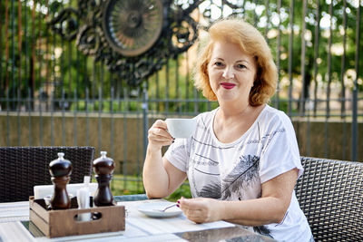 Portrait of woman sitting on table