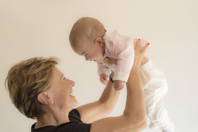 Grandmother hugging and smiling her granddaughter