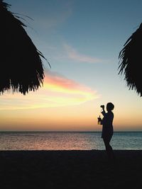Silhouette of man standing on beach