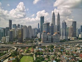 Aerial view of modern buildings in city against sky