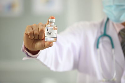 Close-up of human hand holding bottle