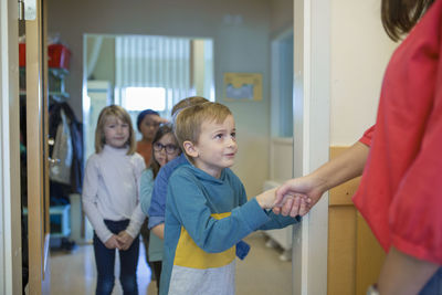 Boy shaking teachers hand