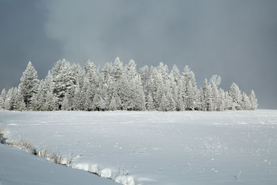 Frozen lake against sky during winter