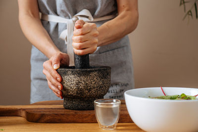 Midsection of woman preparing food on table