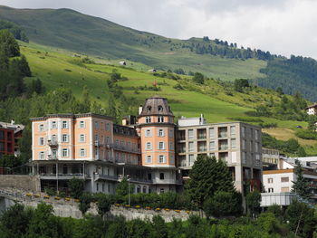 Houses on mountain against sky