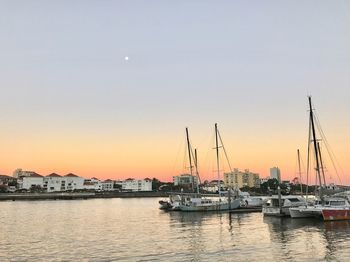 Boats moored at harbor