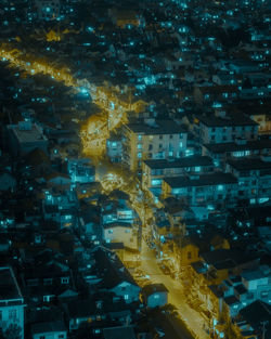 High angle view of illuminated street amidst buildings in city