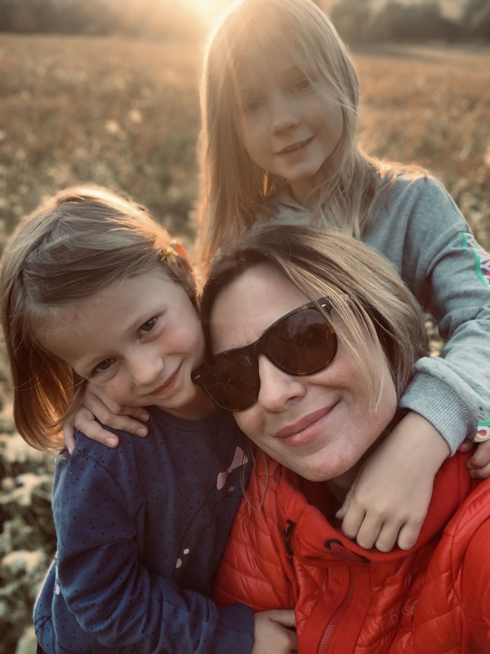 PORTRAIT OF A SMILING GIRL WITH MOTHER