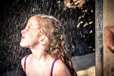 Girl taking shower at beach