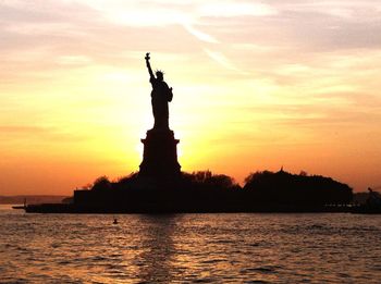 Silhouette of statue at sunset