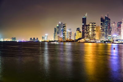 Illuminated buildings in city at night