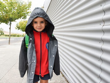 Portrait of a boy going to school in the street