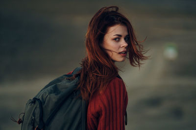 Portrait of a beautiful young woman standing outdoors